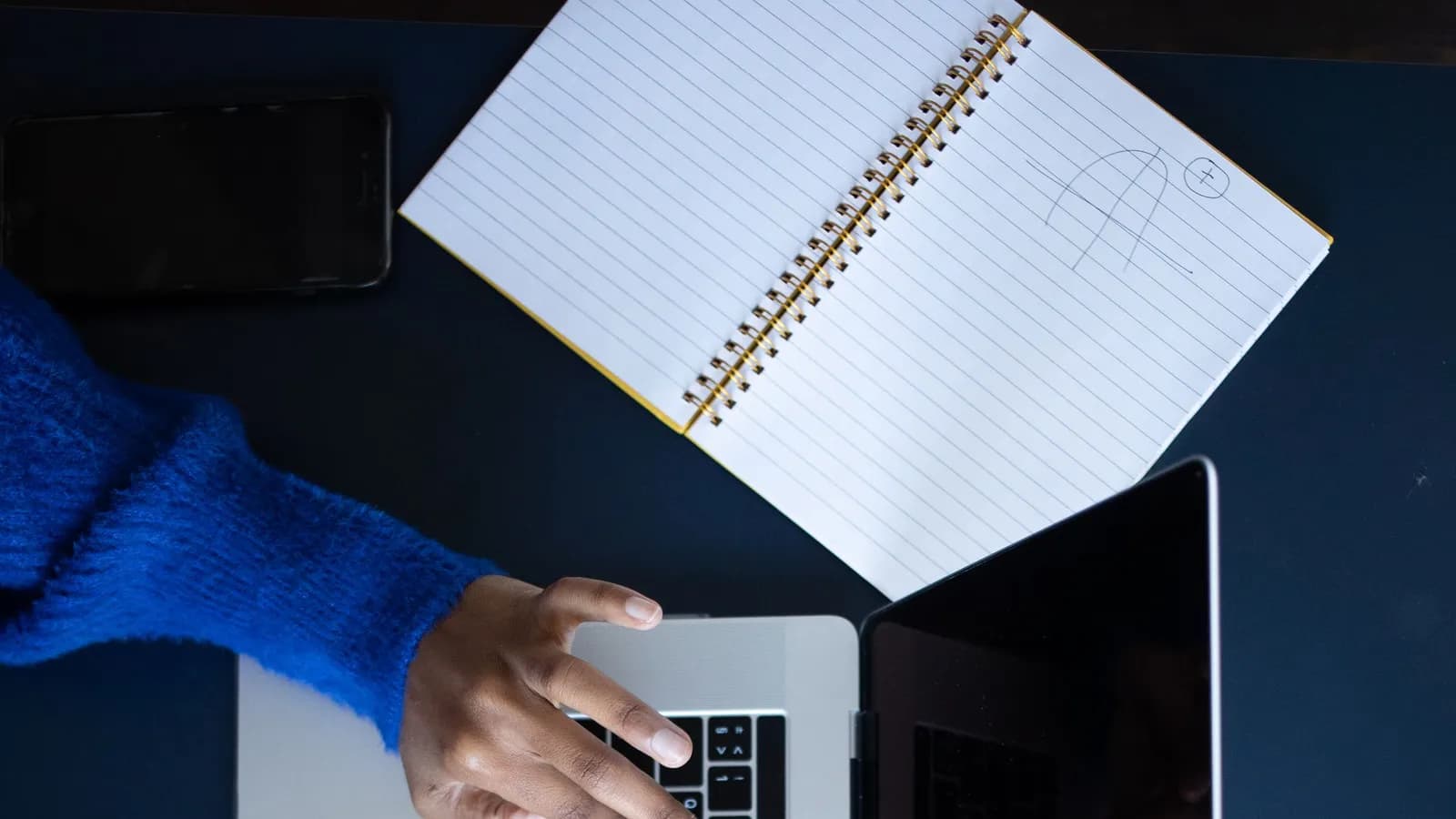 Bàn tay gõ bàn phím laptop khi soạn nội dung marketing